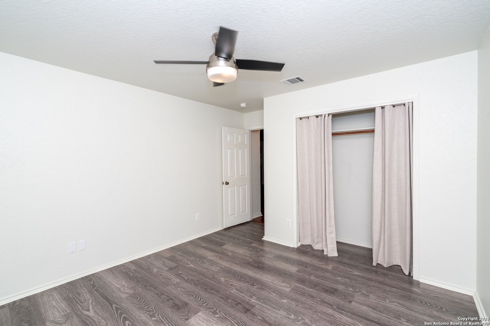 720 Fountain Gate Schertz, TX 78108 - Photo 29 of 34 an empty room with wooden floor ceiling fan and windows