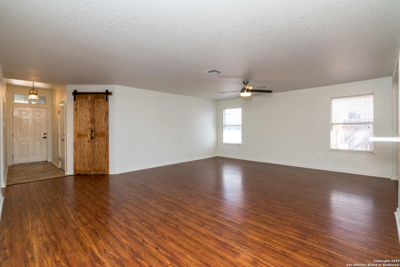 720 Fountain Gate Schertz, TX 78108 - Photo 6 of 34 an empty room with wooden floor and windows