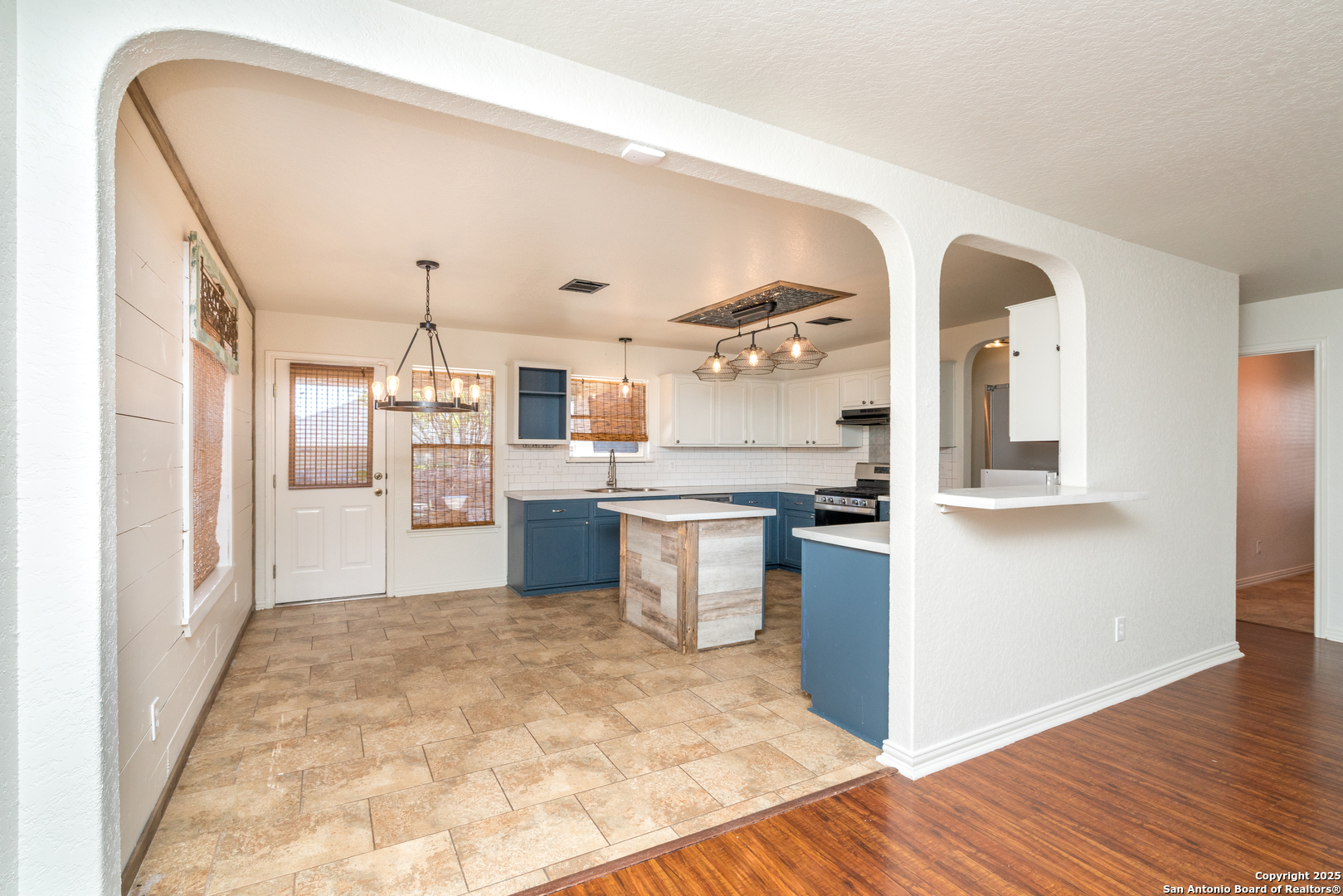 720 Fountain Gate Schertz, TX 78108 - Photo 10 of 34 a kitchen with stainless steel appliances granite countertop a refrigerator a sink a stove and oven with wooden floor