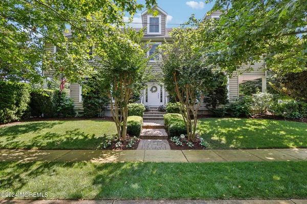a view of entryway livingroom and hall with wooden floor