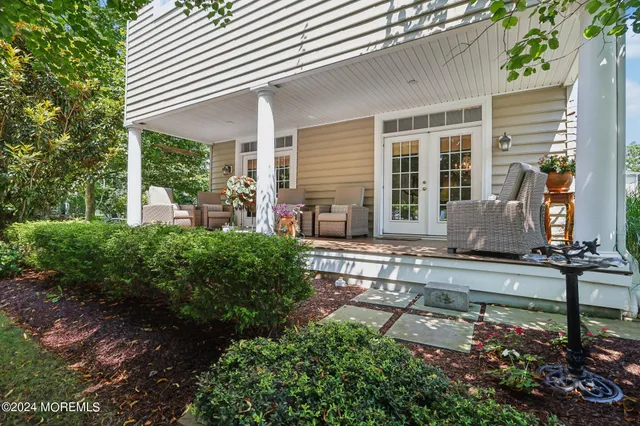 a large kitchen with stainless steel appliances granite countertop a stove a sink dishwasher and a refrigerator with wooden floor