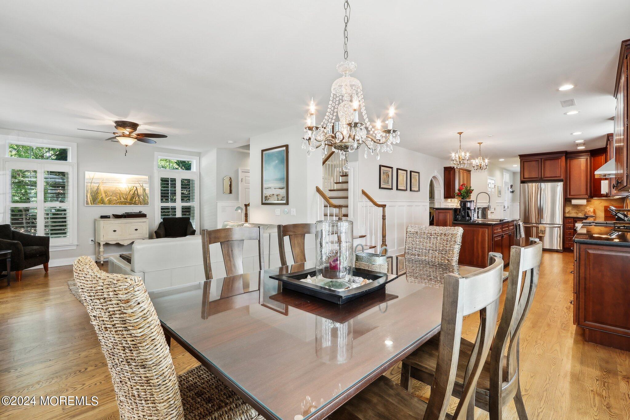 317 Worthington Avenue Spring Lake, NJ 07762 - Photo 19 of 85 a living room with dining table and a chandelier