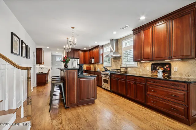 a view of a kitchen with stainless steel appliances granite countertop a refrigerator and a sink