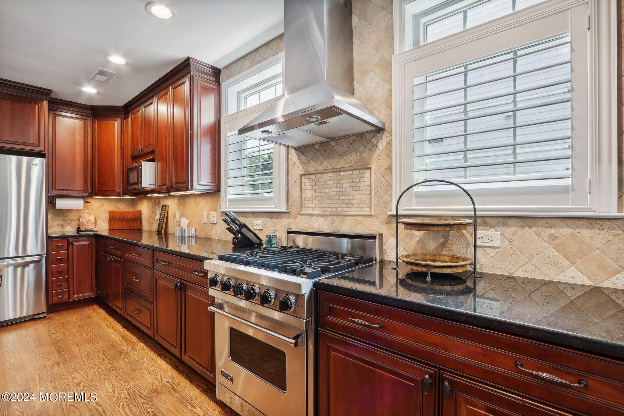 317 Worthington Avenue Spring Lake, NJ 07762 - Photo 24 of 85 a kitchen with stainless steel appliances granite countertop a stove a sink and a microwave