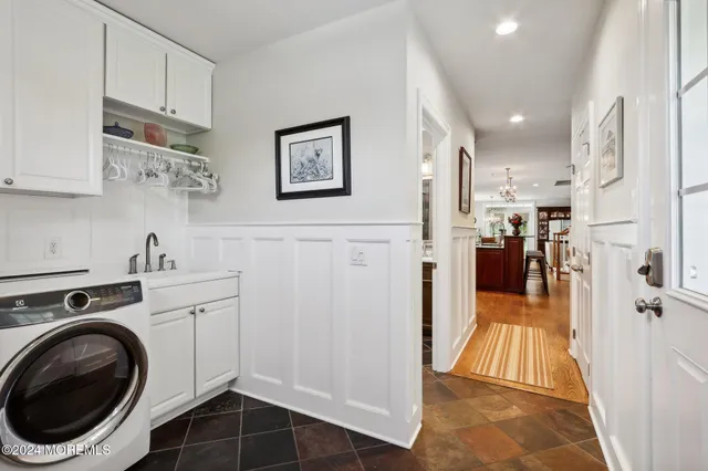 a bathroom with a sink a tub and a mirror