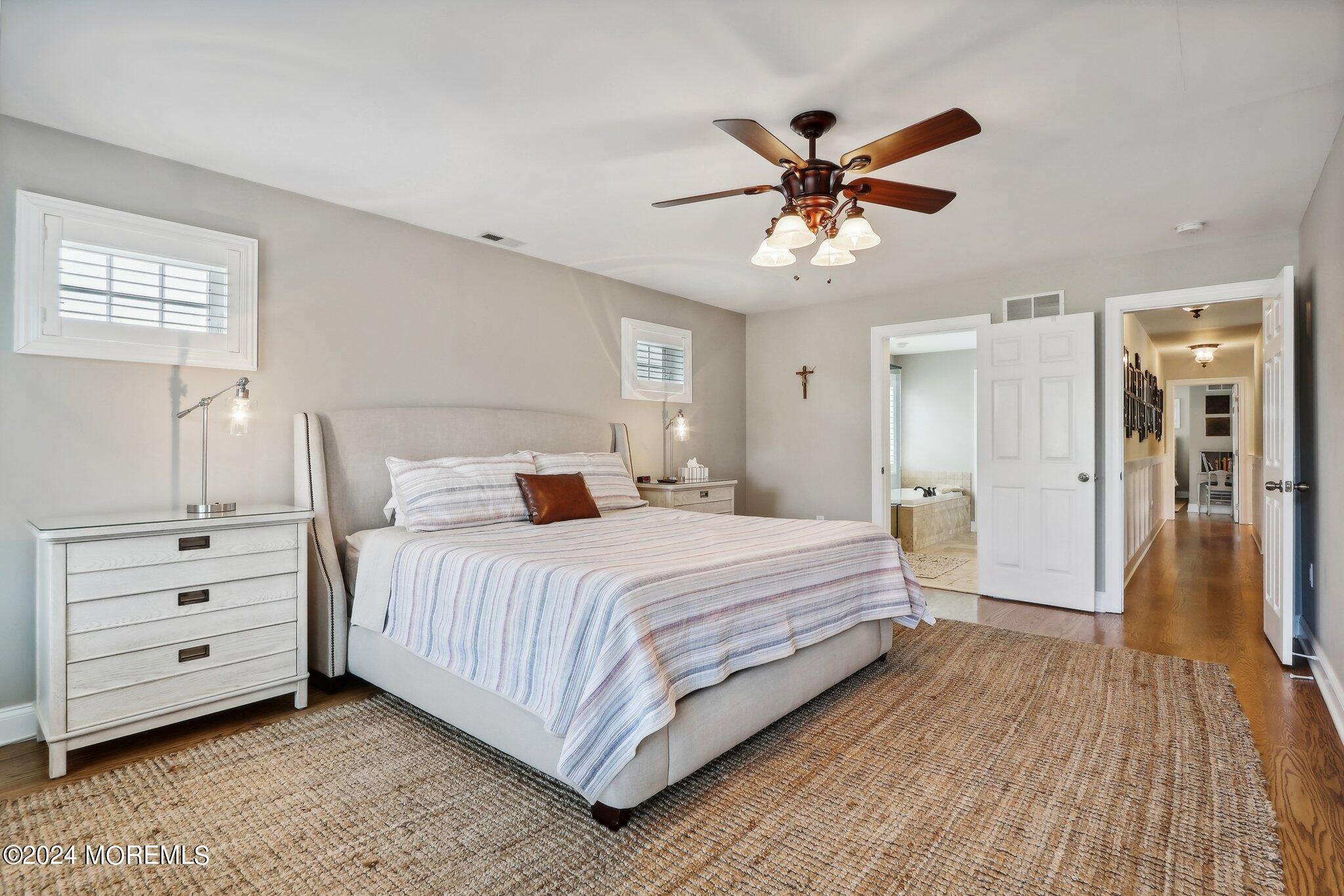 317 Worthington Avenue Spring Lake, NJ 07762 - Photo 37 of 85 a bedroom with a large bed and a chandelier