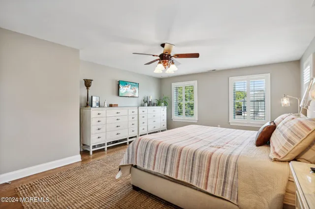 a view of a livingroom with furniture staircase and a ceiling fan