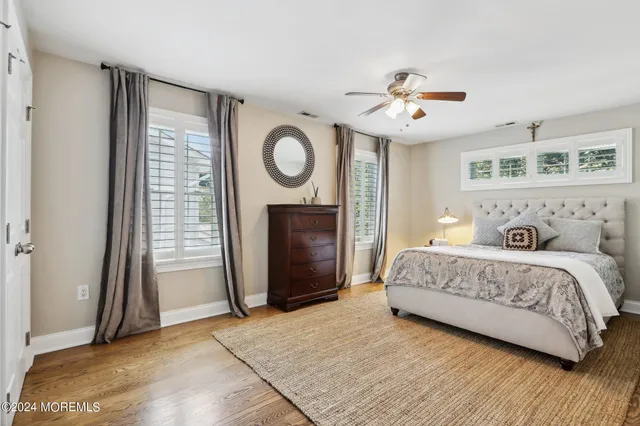 a view of a room with furniture and wooden floor