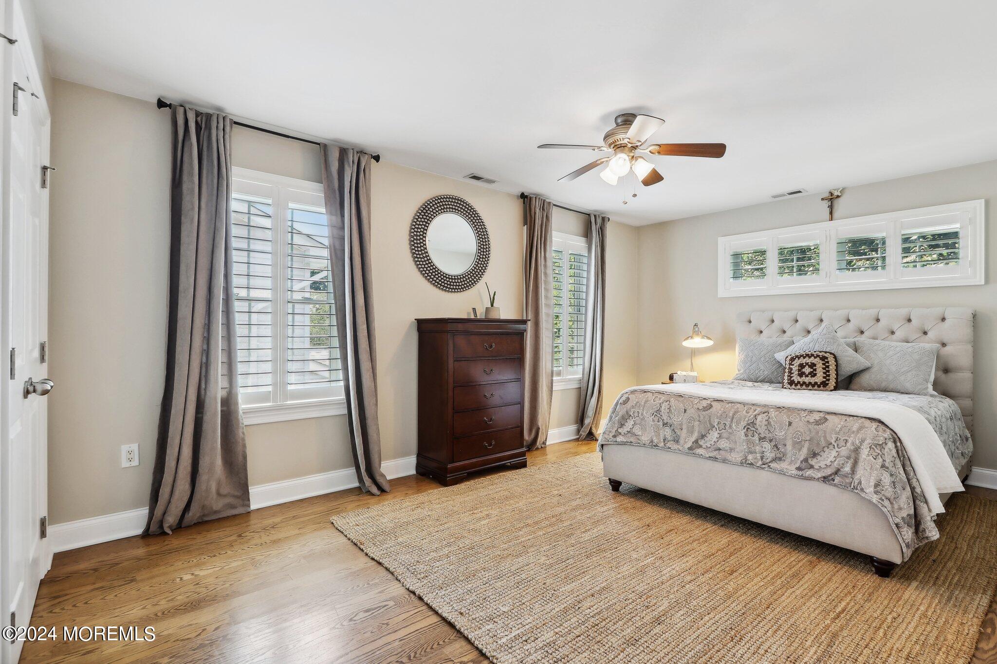 317 Worthington Avenue Spring Lake, NJ 07762 - Photo 43 of 85 a spacious bedroom with a bed and a fireplace