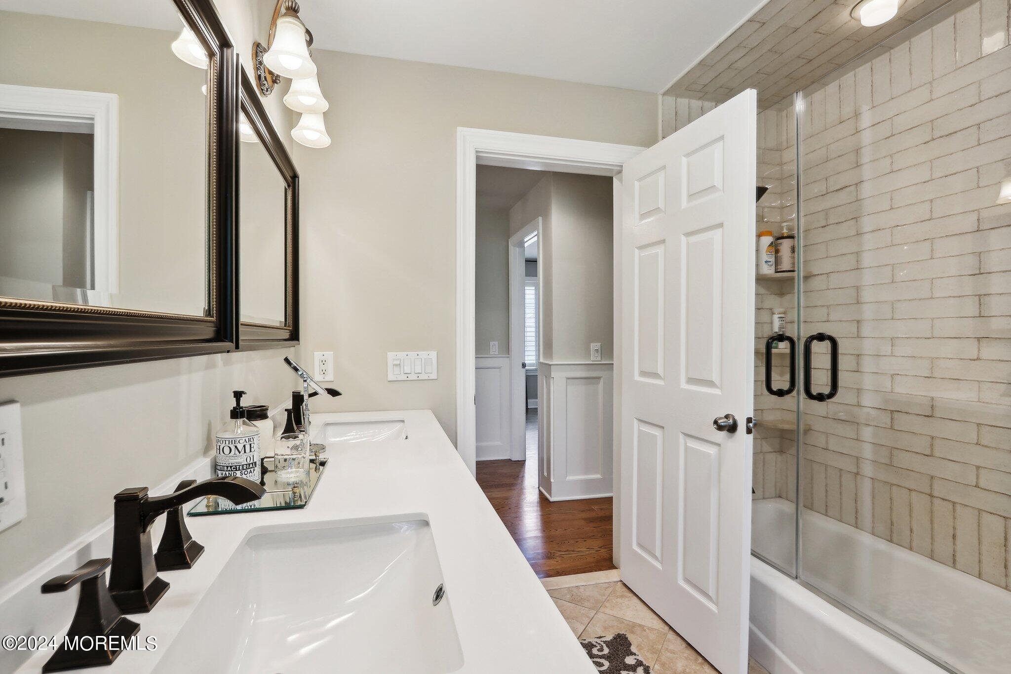 317 Worthington Avenue Spring Lake, NJ 07762 - Photo 46 of 85 a bathroom with a sink a tub and a mirror