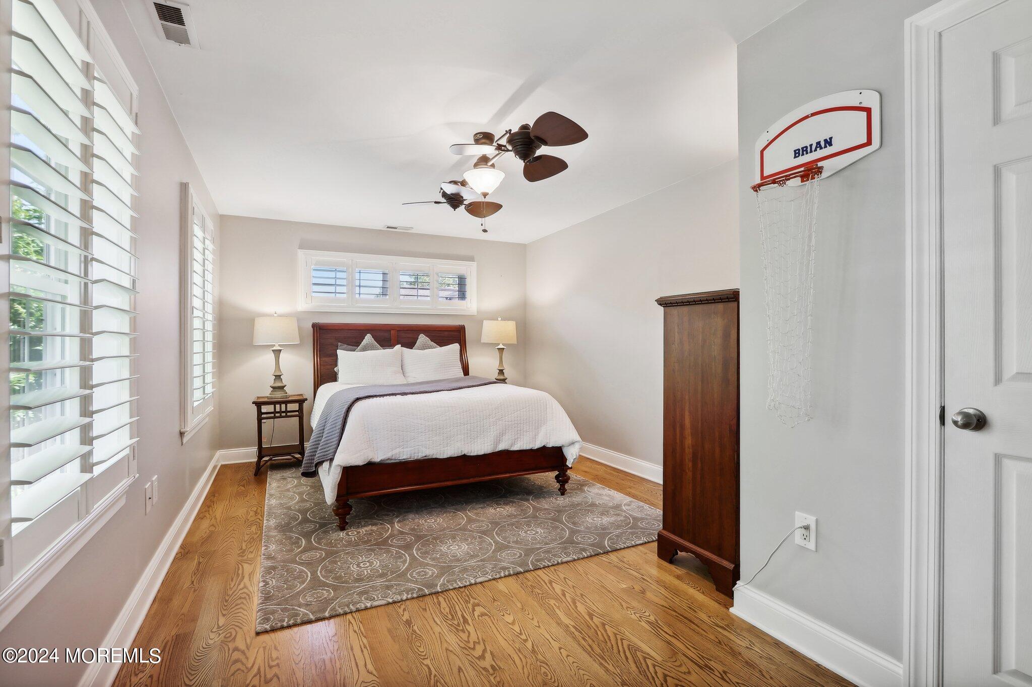 317 Worthington Avenue Spring Lake, NJ 07762 - Photo 47 of 85 a bedroom with a bed and wooden floor