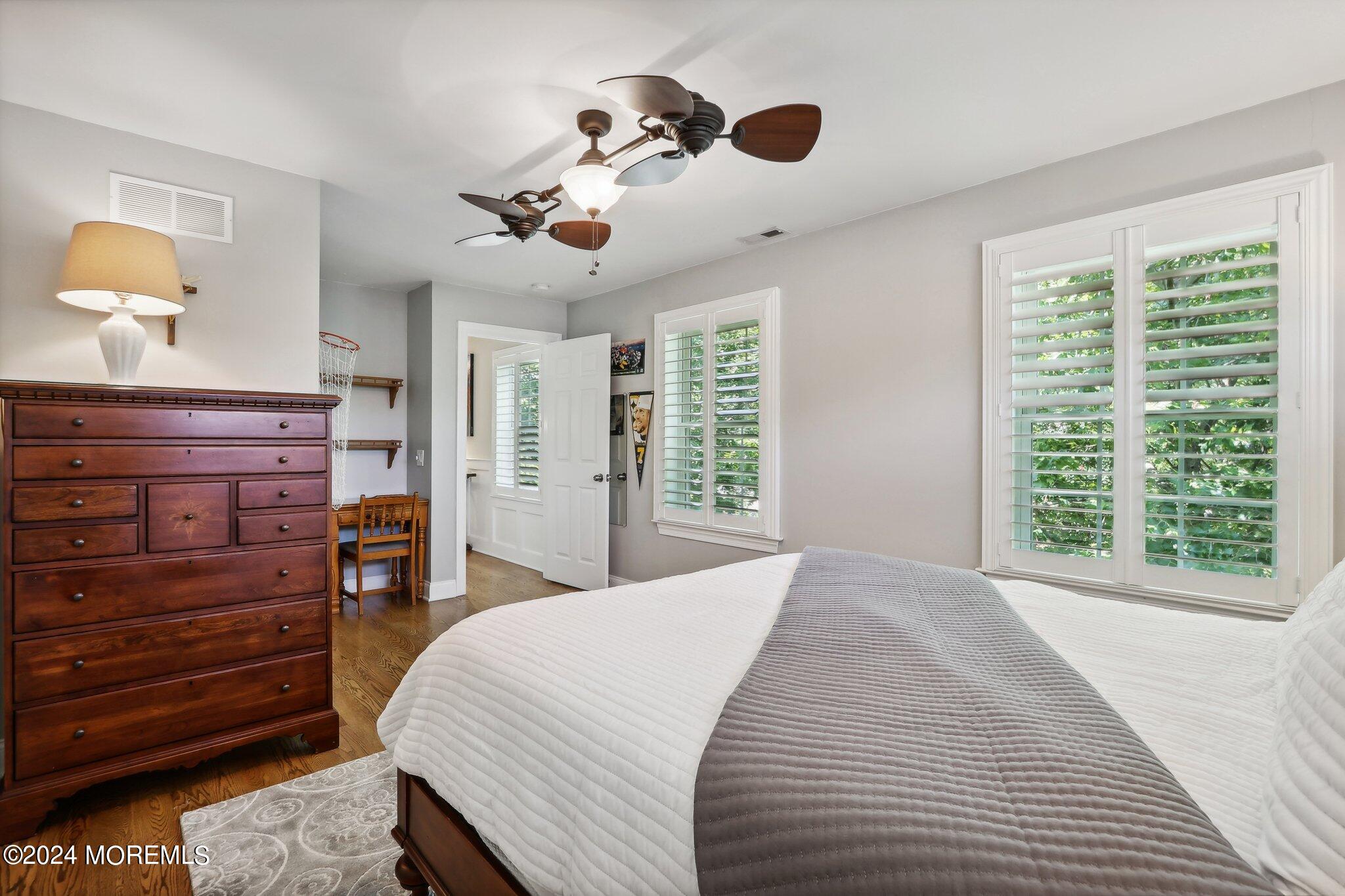 317 Worthington Avenue Spring Lake, NJ 07762 - Photo 48 of 85 a bedroom with a large bed and a chandelier