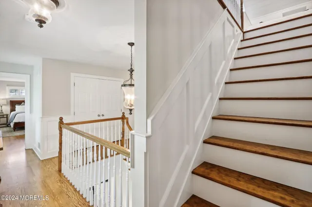 a front view of a house with a yard and potted plants