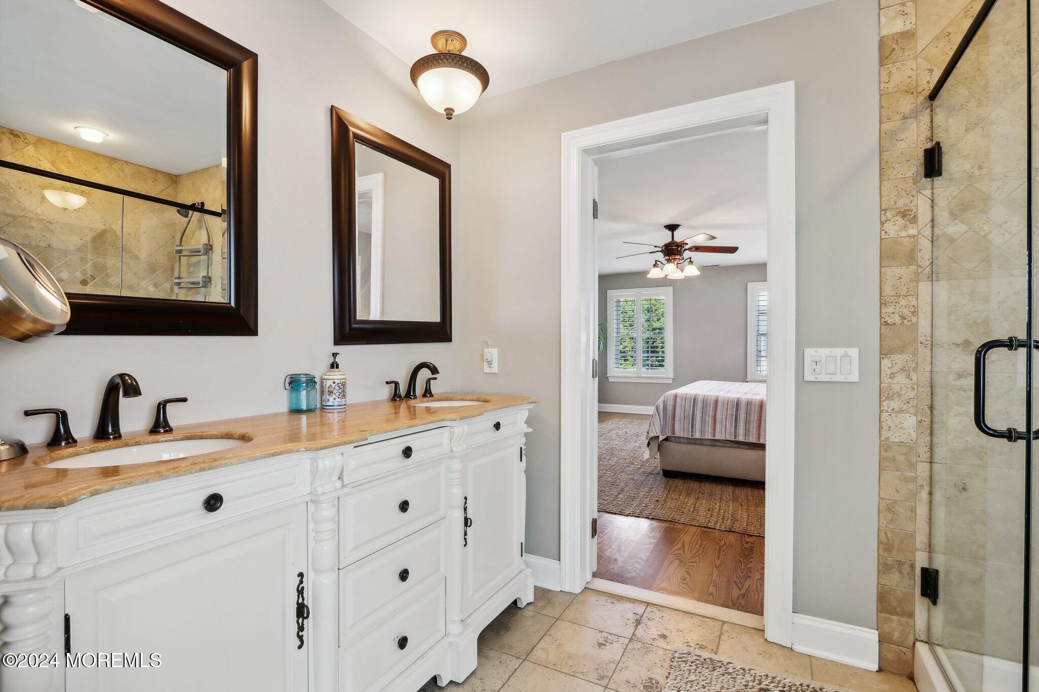 317 Worthington Avenue Spring Lake, NJ 07762 - Photo 50 of 85 a en suite bathroom with a double vanity sink a mirror a window and a shower