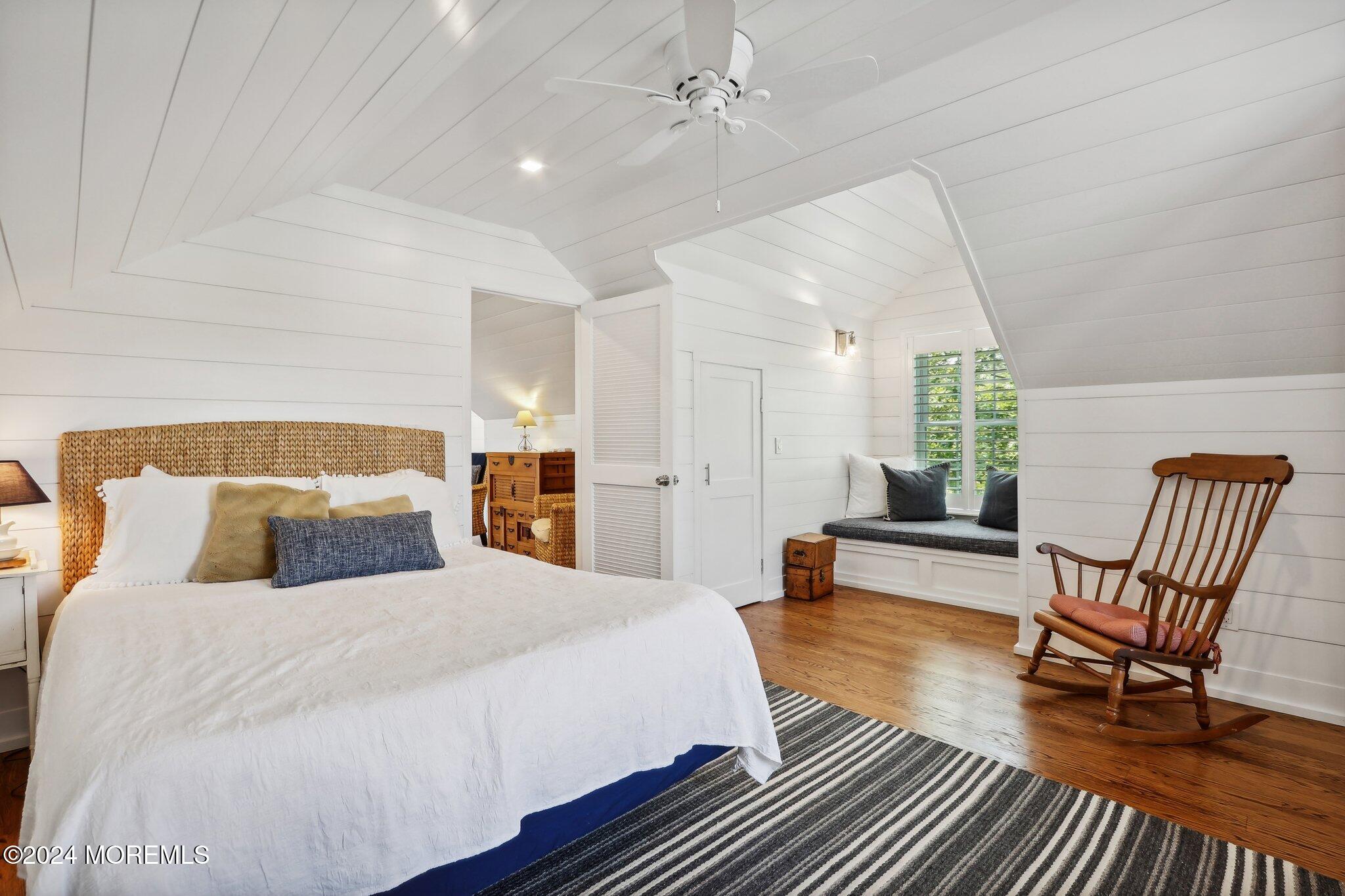 317 Worthington Avenue Spring Lake, NJ 07762 - Photo 61 of 85 a bedroom with a bed a chair and potted plant on dresser