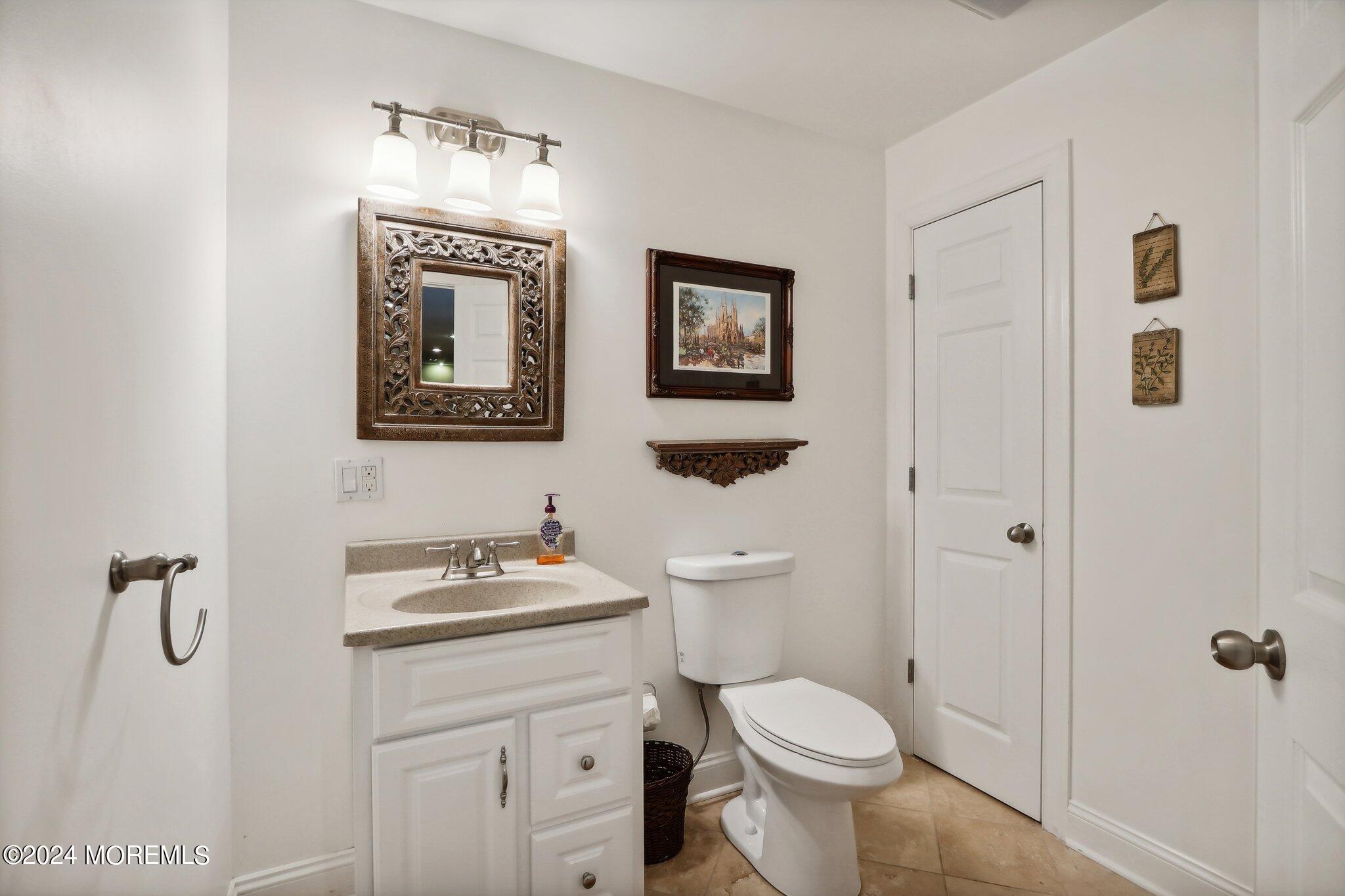 317 Worthington Avenue Spring Lake, NJ 07762 - Photo 68 of 85 a bathroom with a toilet sink and mirror