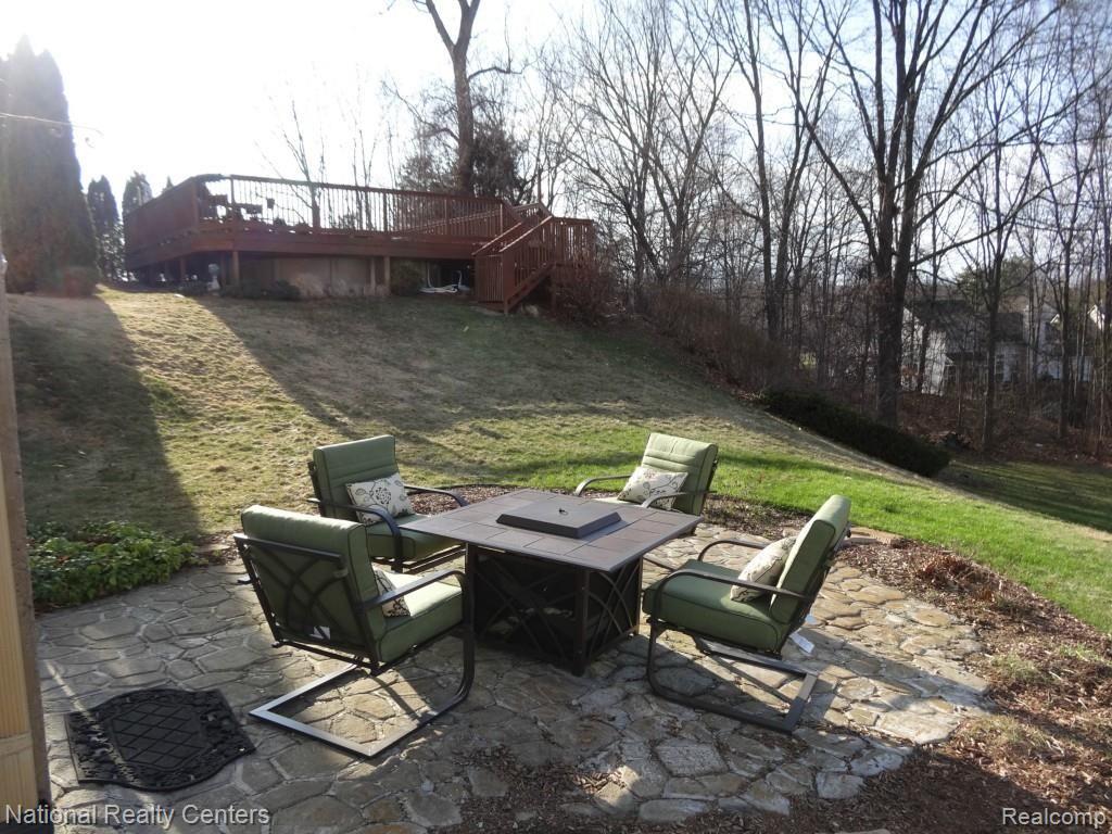 4335 North Ridge Drive Pinckney, MI 48169 - Photo 8 of 42 Pool sits away from home with surround deck and locking gate.