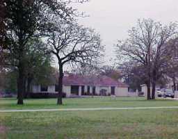 a front view of a building with trees