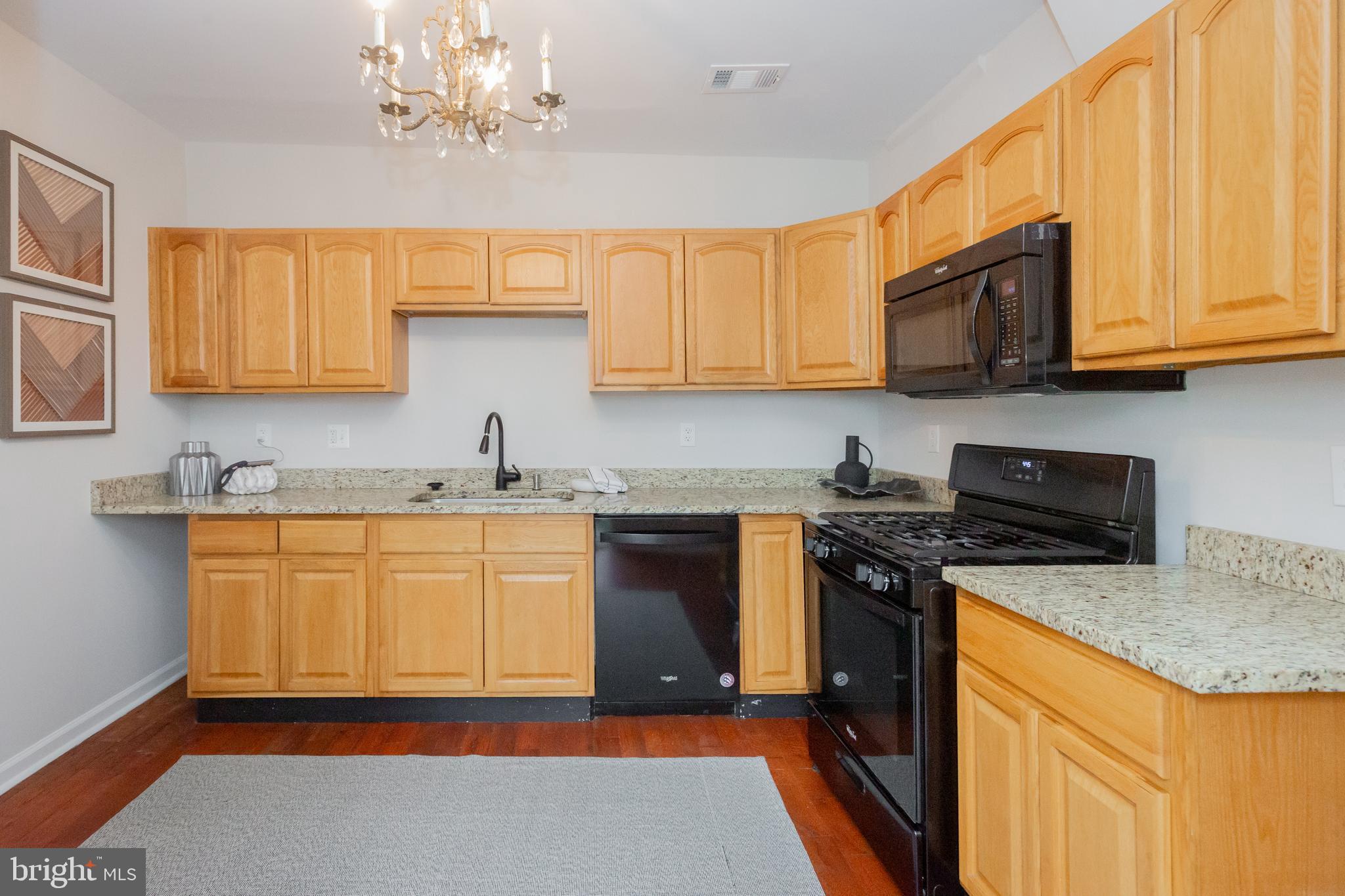 2129 Channing Street Northeast Washington, DC 20018 - Photo 12 of 37 a kitchen with stainless steel appliances granite countertop a sink stove and refrigerator