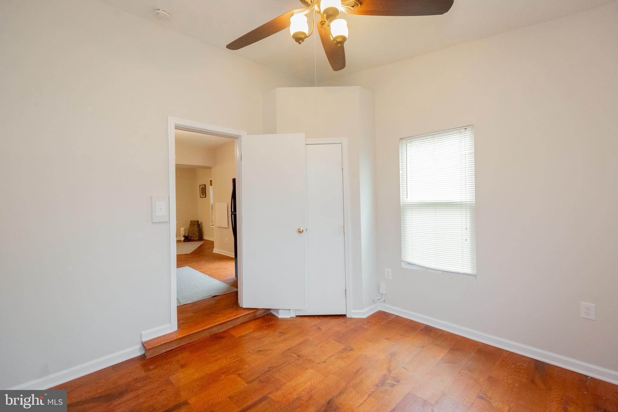 2129 Channing Street Northeast Washington, DC 20018 - Photo 14 of 37 an empty room with a window and chandelier fan