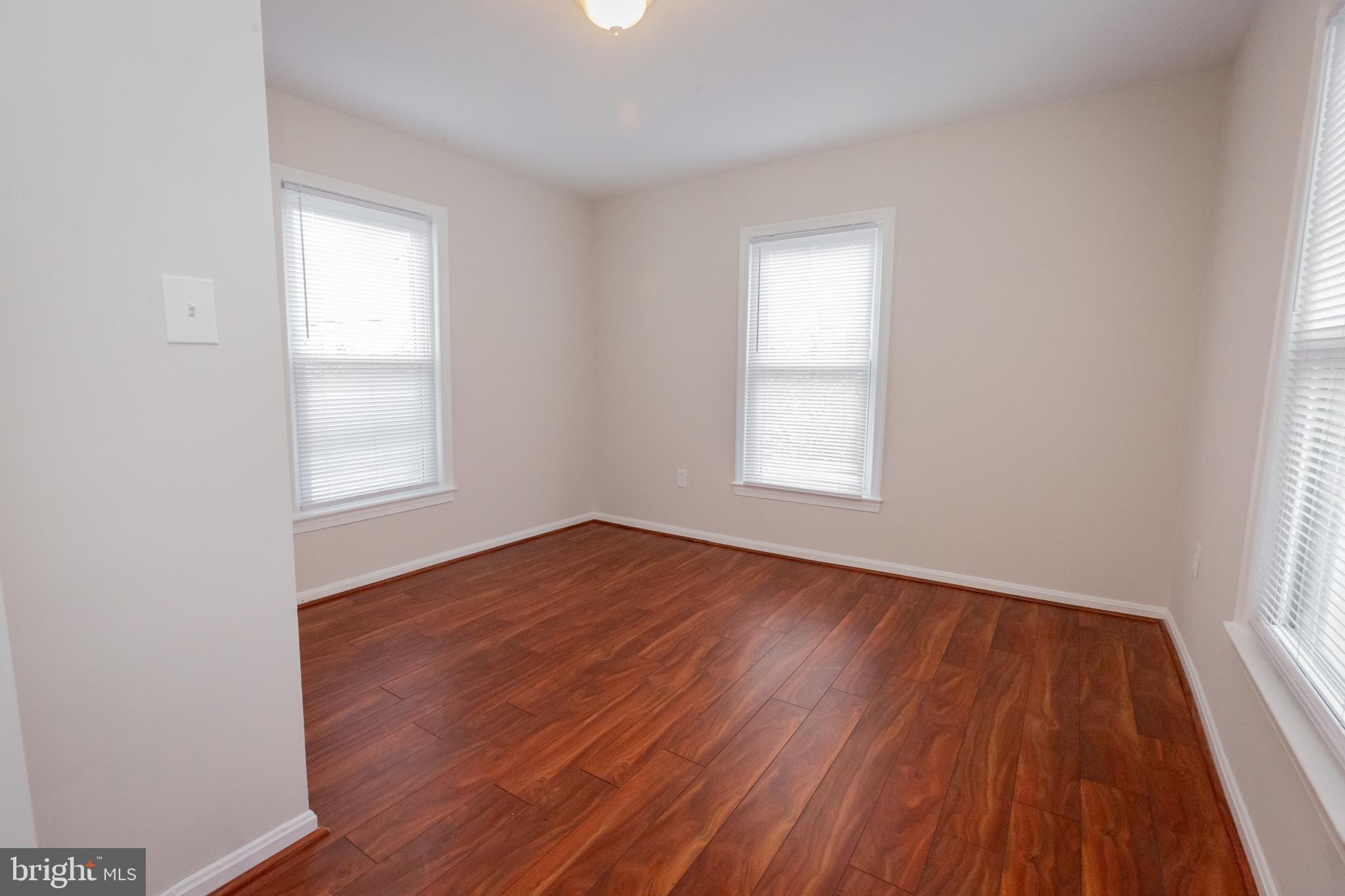 2129 Channing Street Northeast Washington, DC 20018 - Photo 23 of 37 an empty room with wooden floor and windows