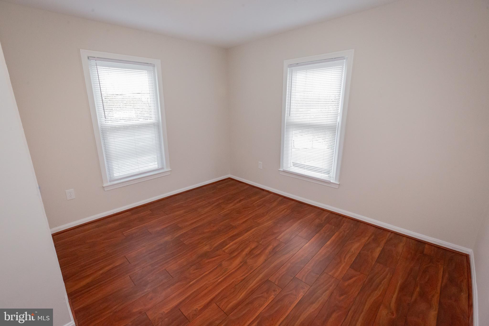 2129 Channing Street Northeast Washington, DC 20018 - Photo 25 of 37 an empty room with wooden floor and windows