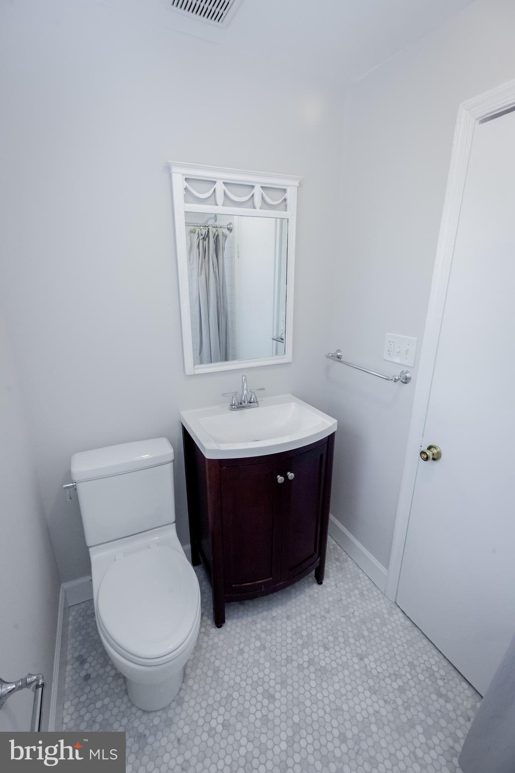 2129 Channing Street Northeast Washington, DC 20018 - Photo 26 of 37 a bathroom with a toilet sink and mirror
