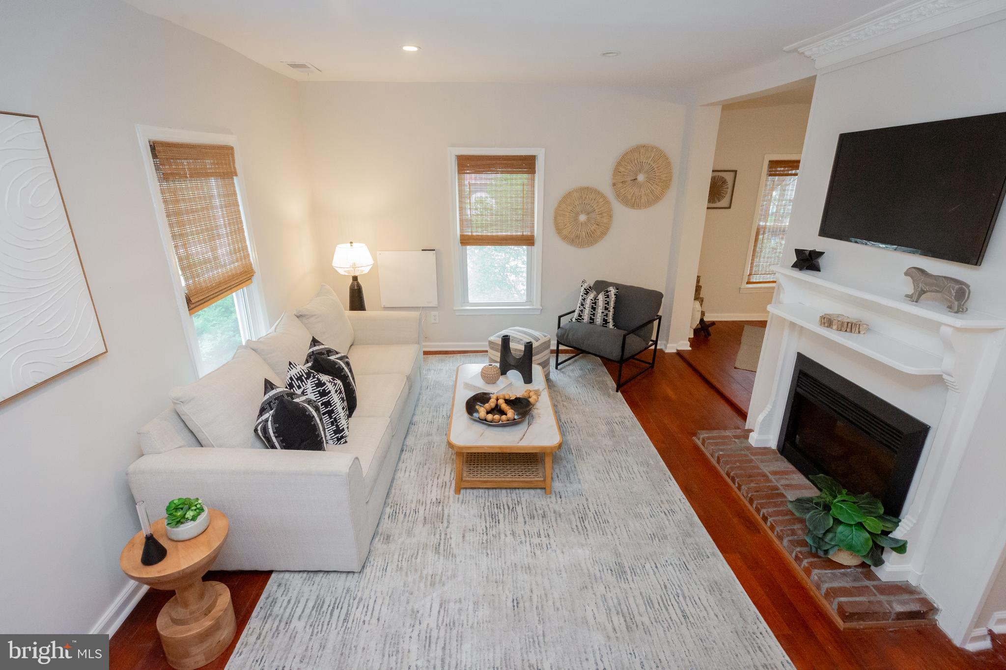 2129 Channing Street Northeast Washington, DC 20018 - Photo 5 of 37 a living room with furniture a flat screen tv and a fireplace