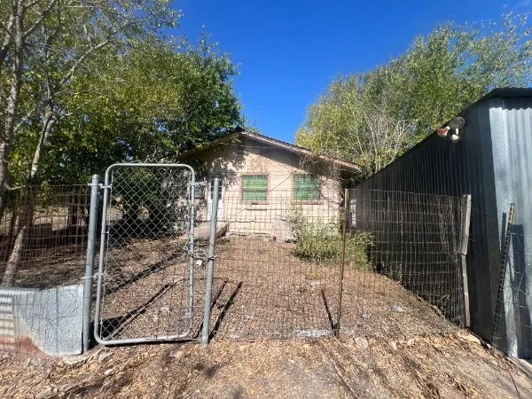 a backyard of a house with table and chairs