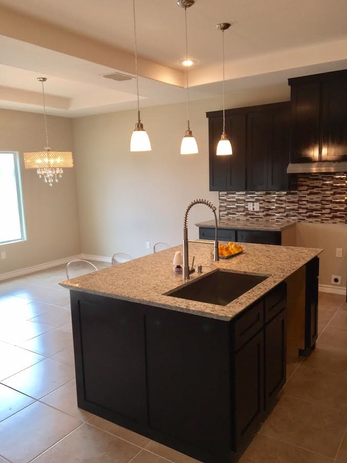 6303 Ramin Court Laredo, TX 78041 - Photo 12 of 20 a kitchen with a sink and a stove