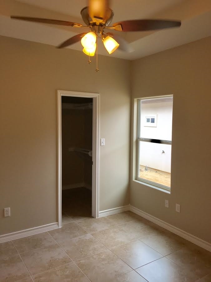 6303 Ramin Court Laredo, TX 78041 - Photo 14 of 20 an empty room with a window and chandelier fan