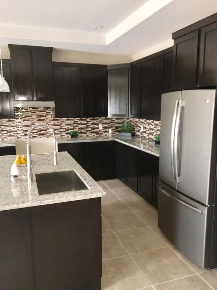 6303 Ramin Court Laredo, TX 78041 - Photo 8 of 20 a kitchen with stainless steel appliances kitchen island sink refrigerator and stove