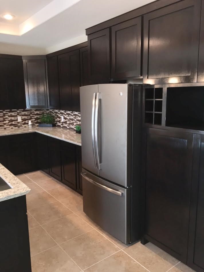6303 Ramin Court Laredo, TX 78041 - Photo 10 of 20 a kitchen with kitchen island a refrigerator and a stove