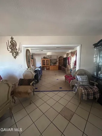 a living room with furniture and a gym machine