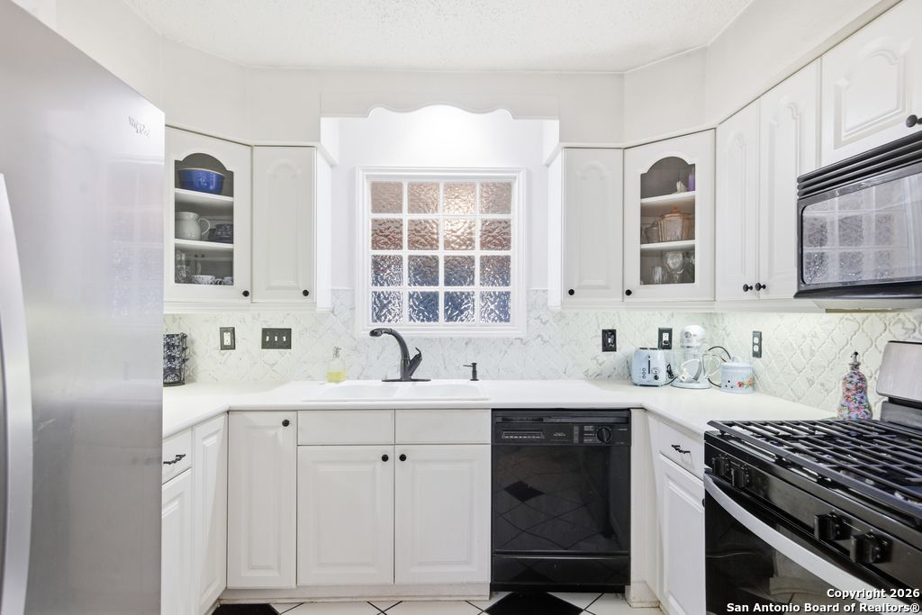 1909 Killarney Drive Leander, TX 78641 - Photo 11 of 29 a kitchen with a sink stove and cabinets