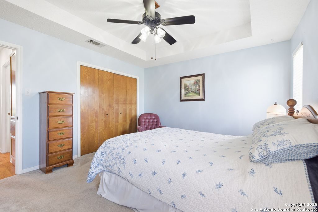 1909 Killarney Drive Leander, TX 78641 - Photo 16 of 29 a bedroom with a bed and a chandelier