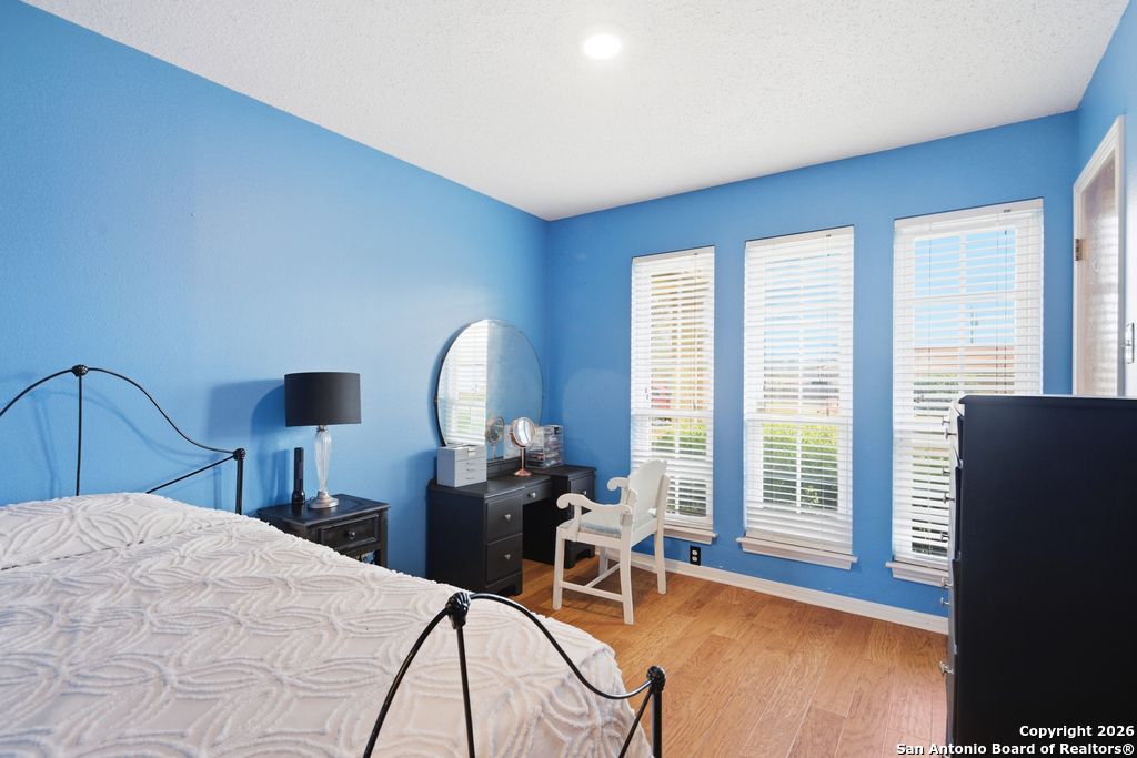 1909 Killarney Drive Leander, TX 78641 - Photo 20 of 29 a bedroom with a bed a chair and a large window