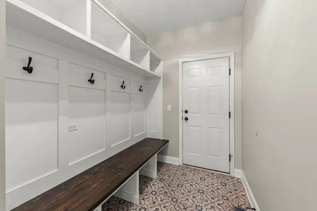 a room with wooden floor and white walls