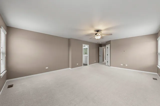 a view of a livingroom with a ceiling fan and window