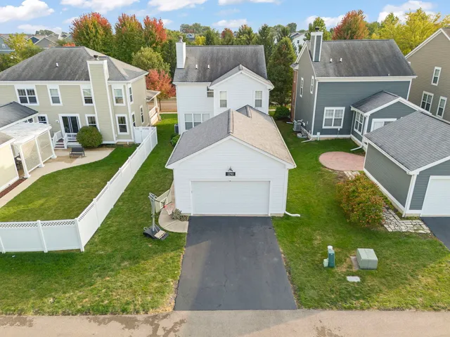 an aerial view of a house with a yard