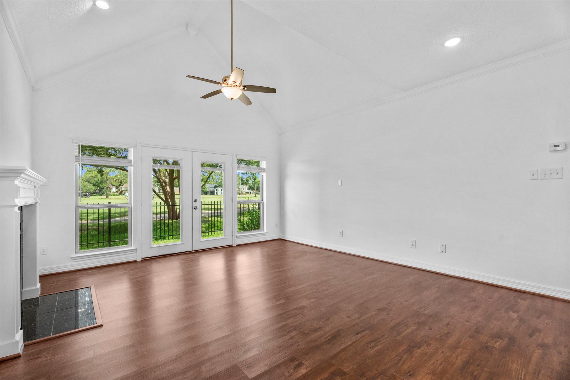 7635 Ameswood Road Houston, TX 77095 - Photo 8 of 39 Sun drenched family room with wall of windows and double doors to the back yard with golf course views.