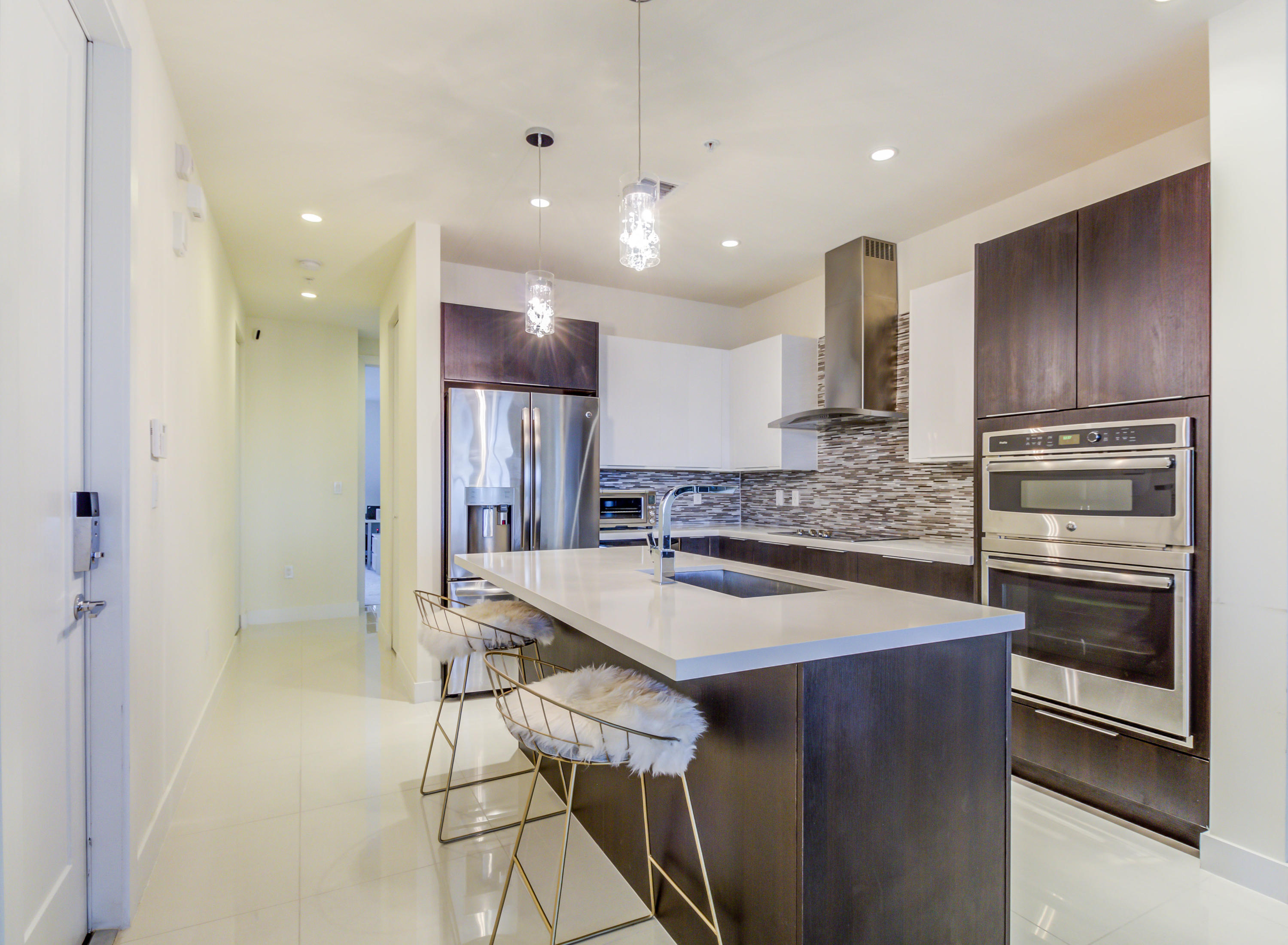 6415 Northwest 102nd Path, Unit 201 Doral, FL 33178 - Photo 2 of 41 a kitchen with kitchen island a sink stainless steel appliances and cabinets