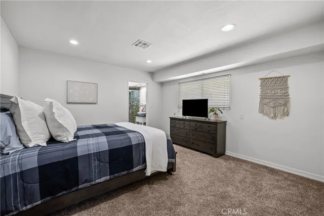 a bed room with a bed and a television