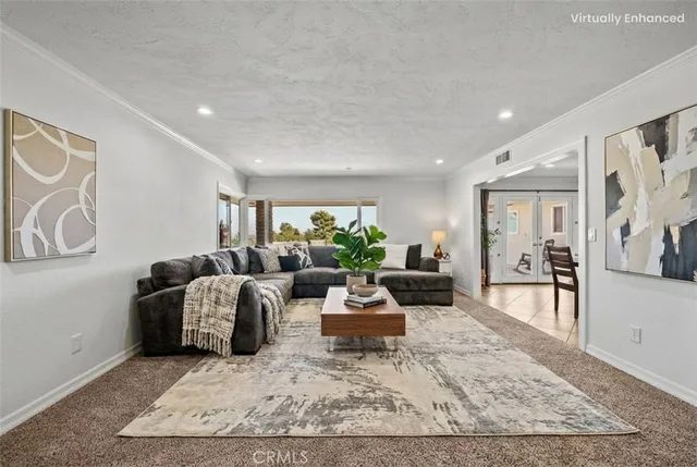 a living room with furniture rug and wooden floor