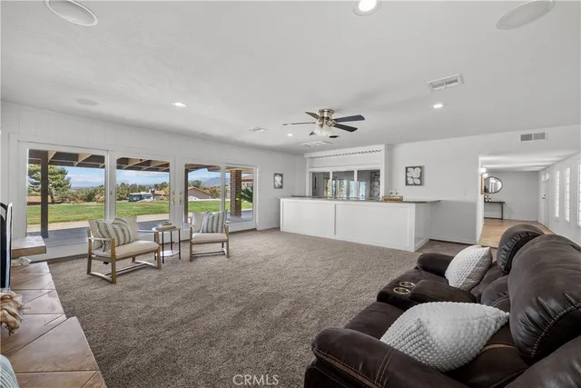 a living room with furniture and large windows