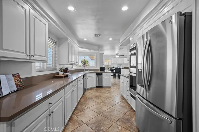 a large kitchen with cabinets and stainless steel appliances