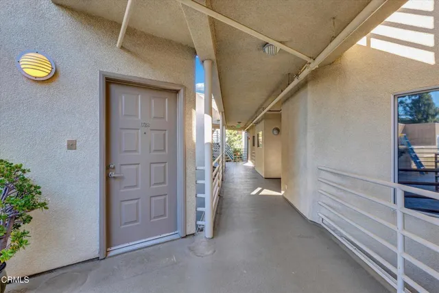 a view of a hallway with wooden shelves