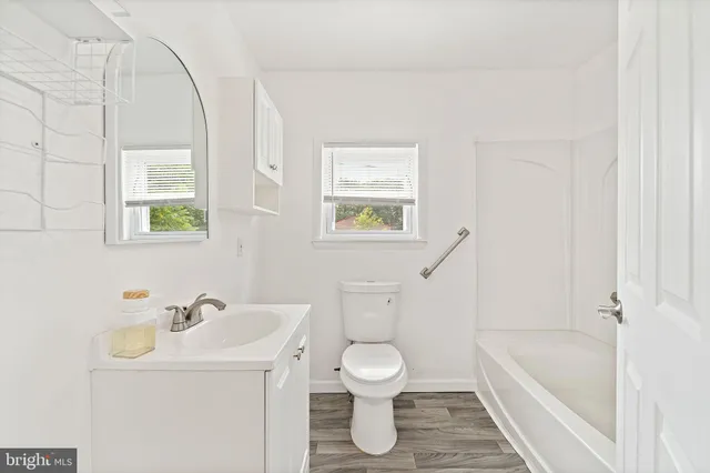 a bathroom with a sink a toilet and a bathtub