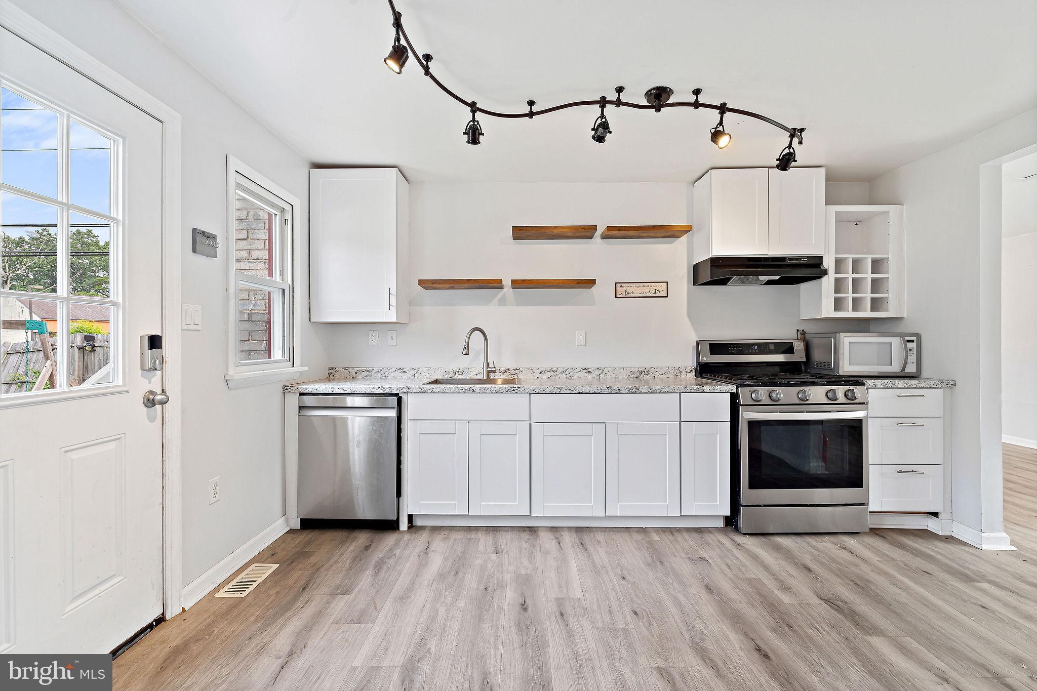 5 Sicklerville Road Sicklerville, NJ 08081 - Photo 9 of 25 a kitchen with granite countertop a sink cabinets stainless steel appliances and a window