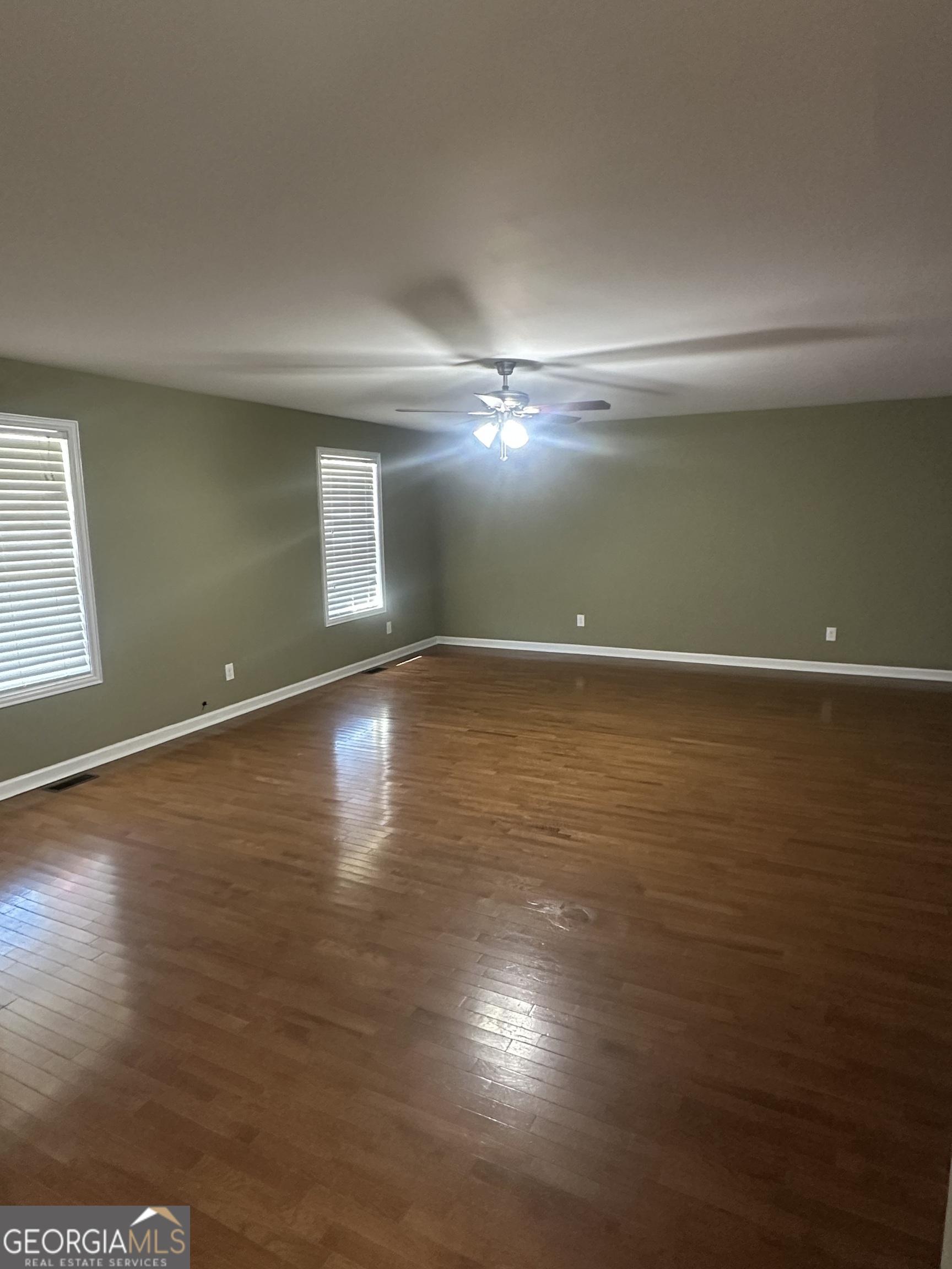 26 Isabelle's Way Colbert, GA 30628 - Photo 21 of 25 a view of an empty room with wooden floor and a window